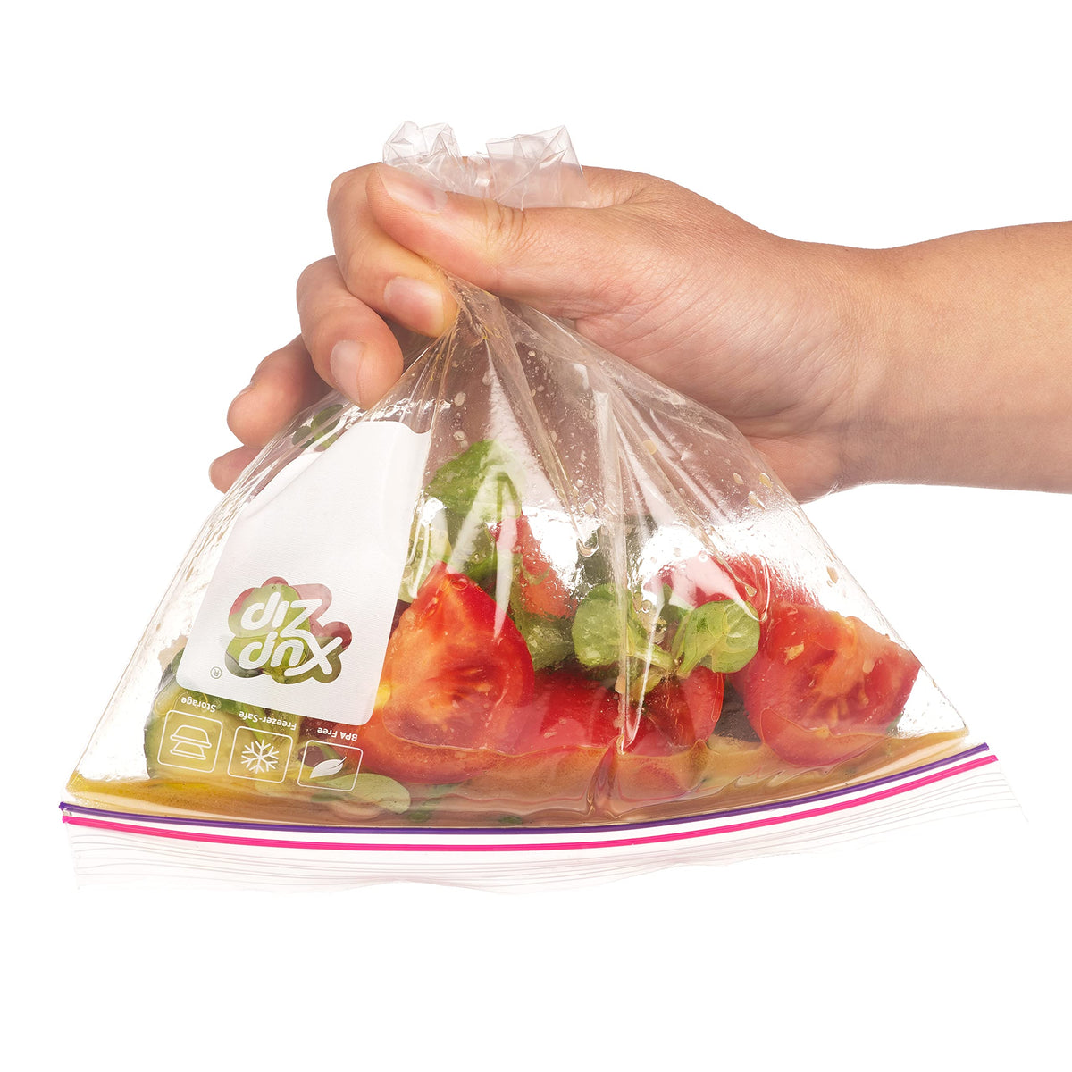 Hand closing the airtight seal of a clear XupZip food storage bag filled with fresh red tomatoes.